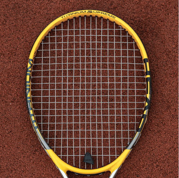 Yellow tennis racket at tennis court