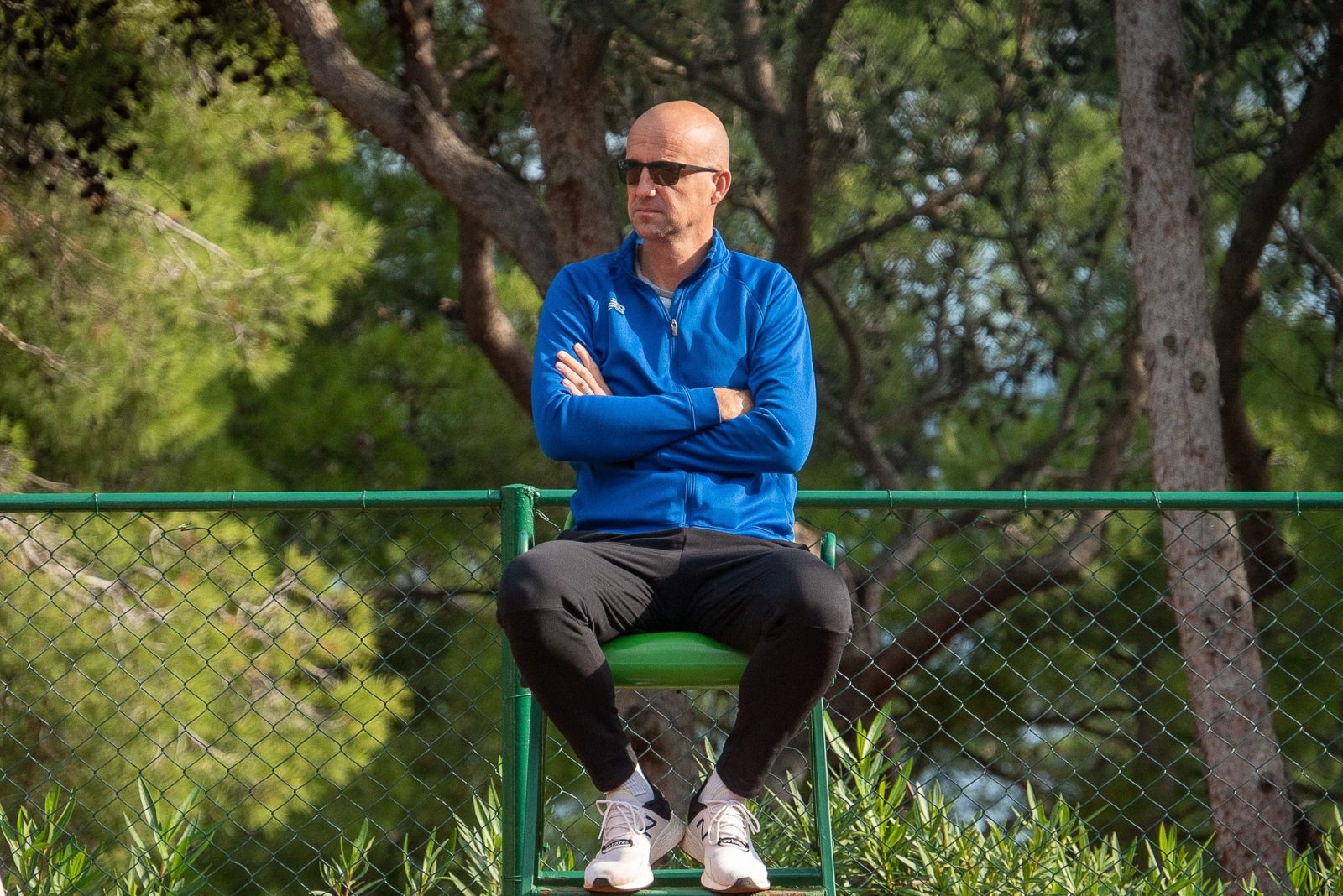 Tennis coach Ivan Ljubicic supervising other tennis players on the court