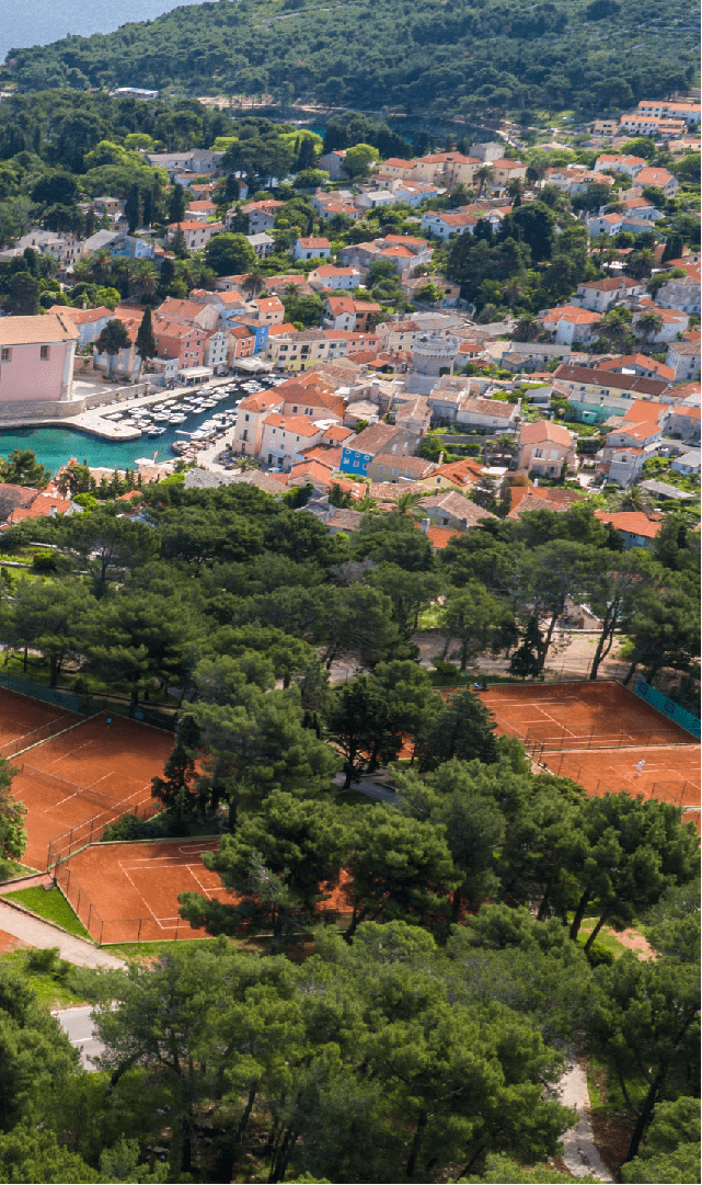 Vitality Hotel Punta and tennis courts at Ljubicic Tennis Academy where we see city of Veli Lošinj